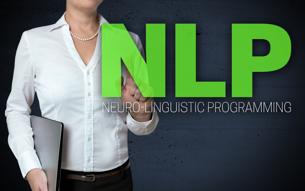 Woman pointing to words that say NLP Neuro-Linguistic Programming